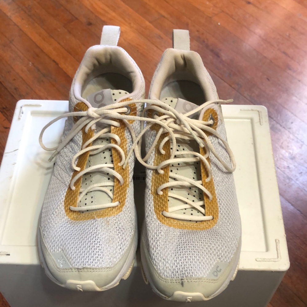 On Running White and Gold Sneakers
